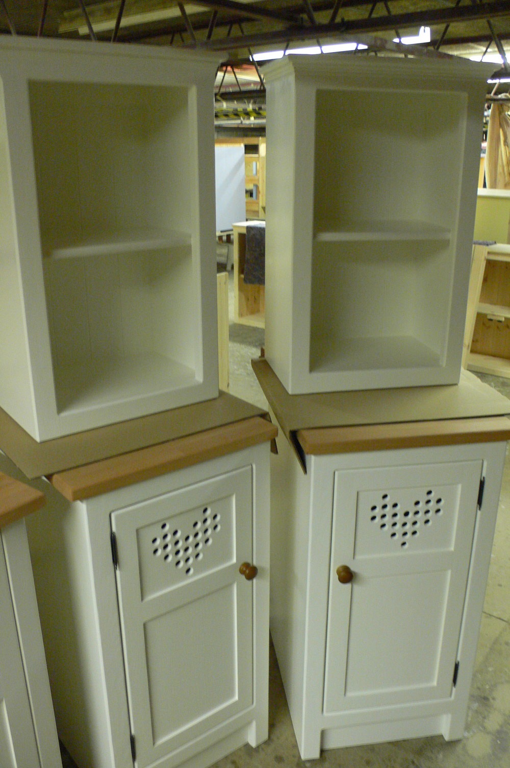 BU22 pair heart motif cupboards and open top cupboards